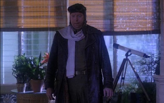 major briggs in retro flying gear next to a telescope