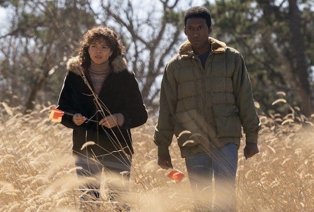 Amelia (Carmen Ejogo) and Wayne (Mahershala Ali) walk through a field in HBO's True Detective