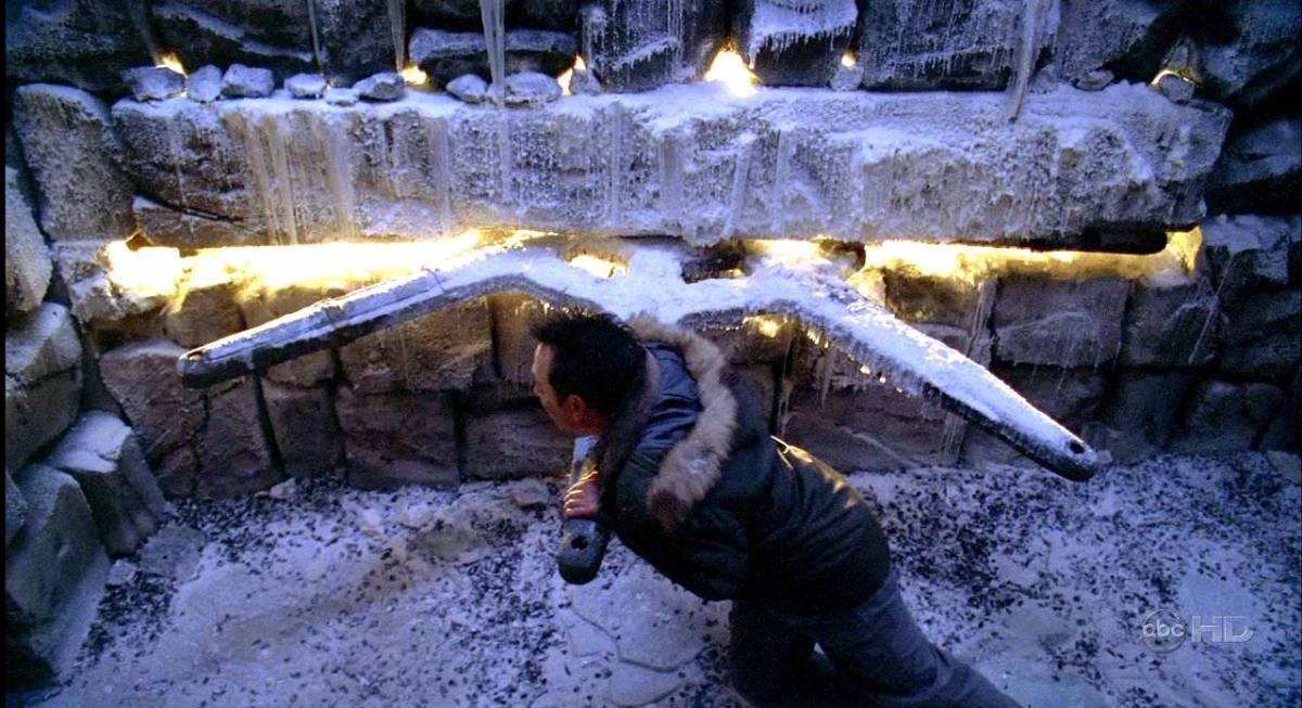 Ben struggles to move the frozen underground wheel