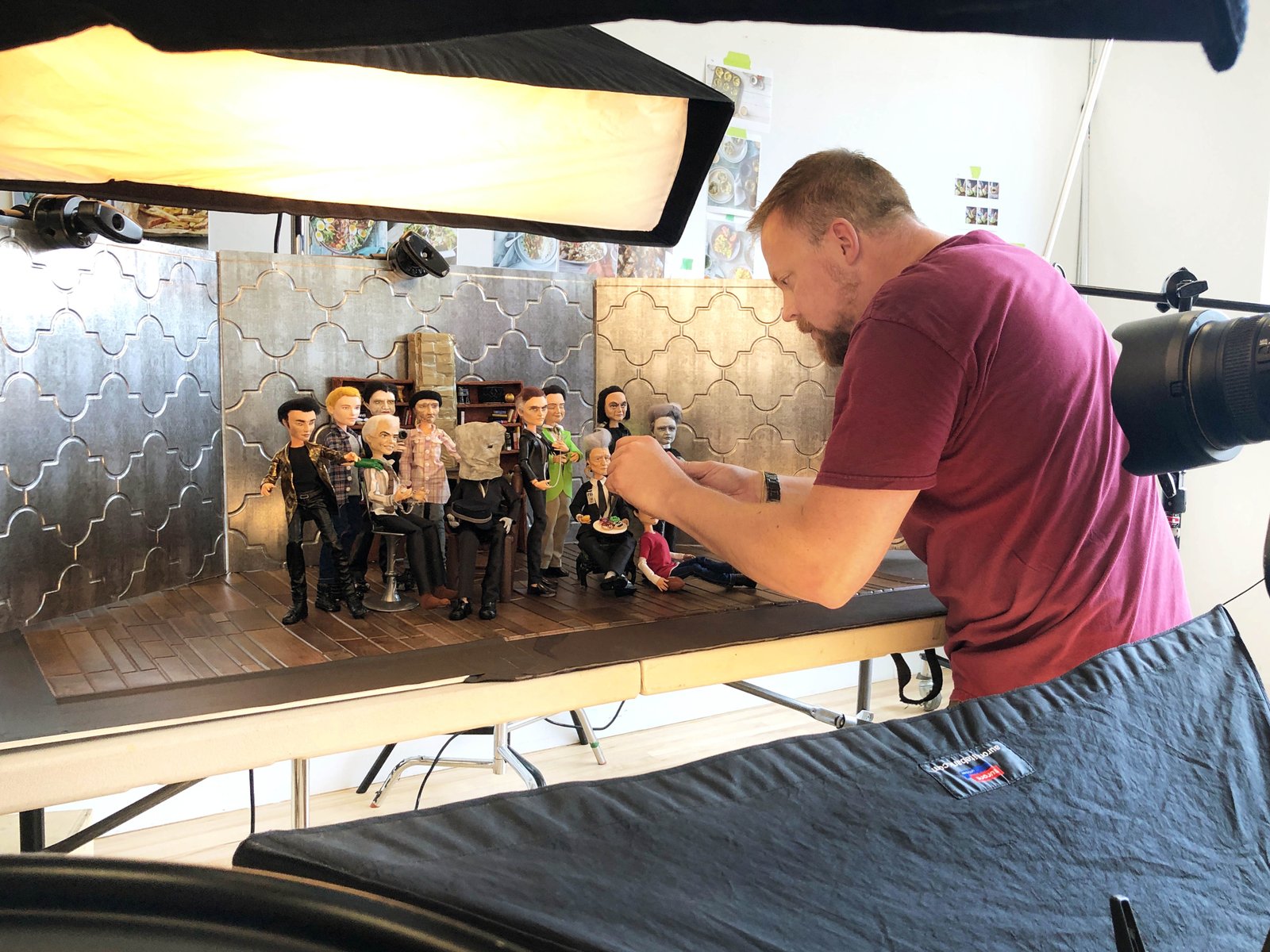 Blake Morrow setting up Milly Henley's Men of Lynch dolls to be photographed