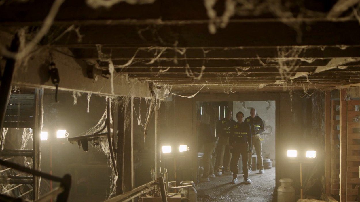 Police enter a decrepit barn to begin their search