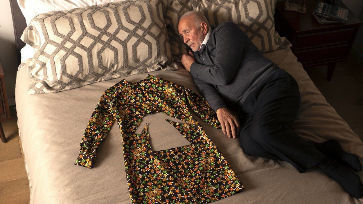 Seb lays in bed next to his ex wife's dress