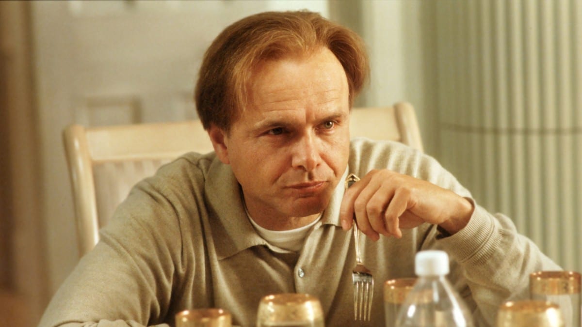 Ralph stares ahead while sitting at Tony's table