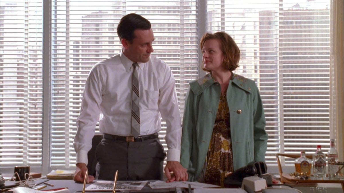 Don takes Peggy by the hand in his office