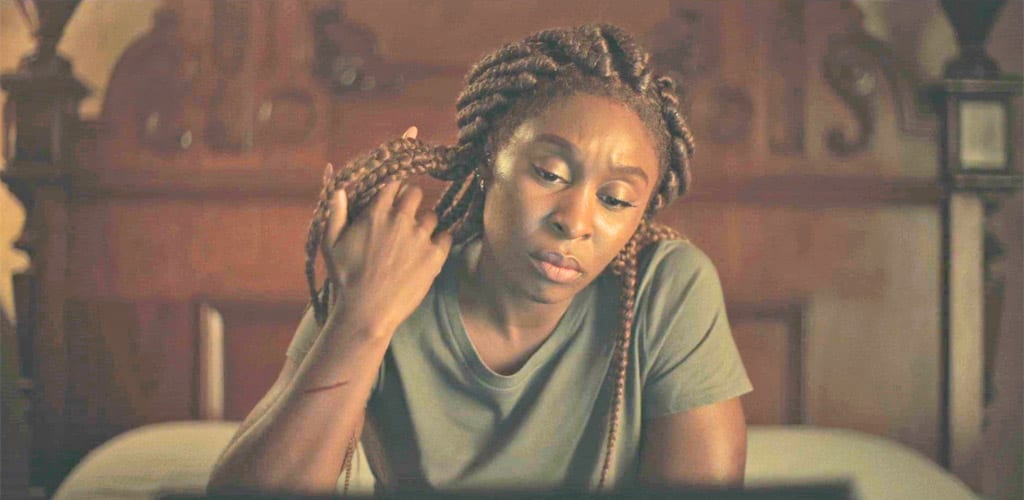 Holly stares at her laptop while a scratch is visible on her arm in The Outsider S1E10