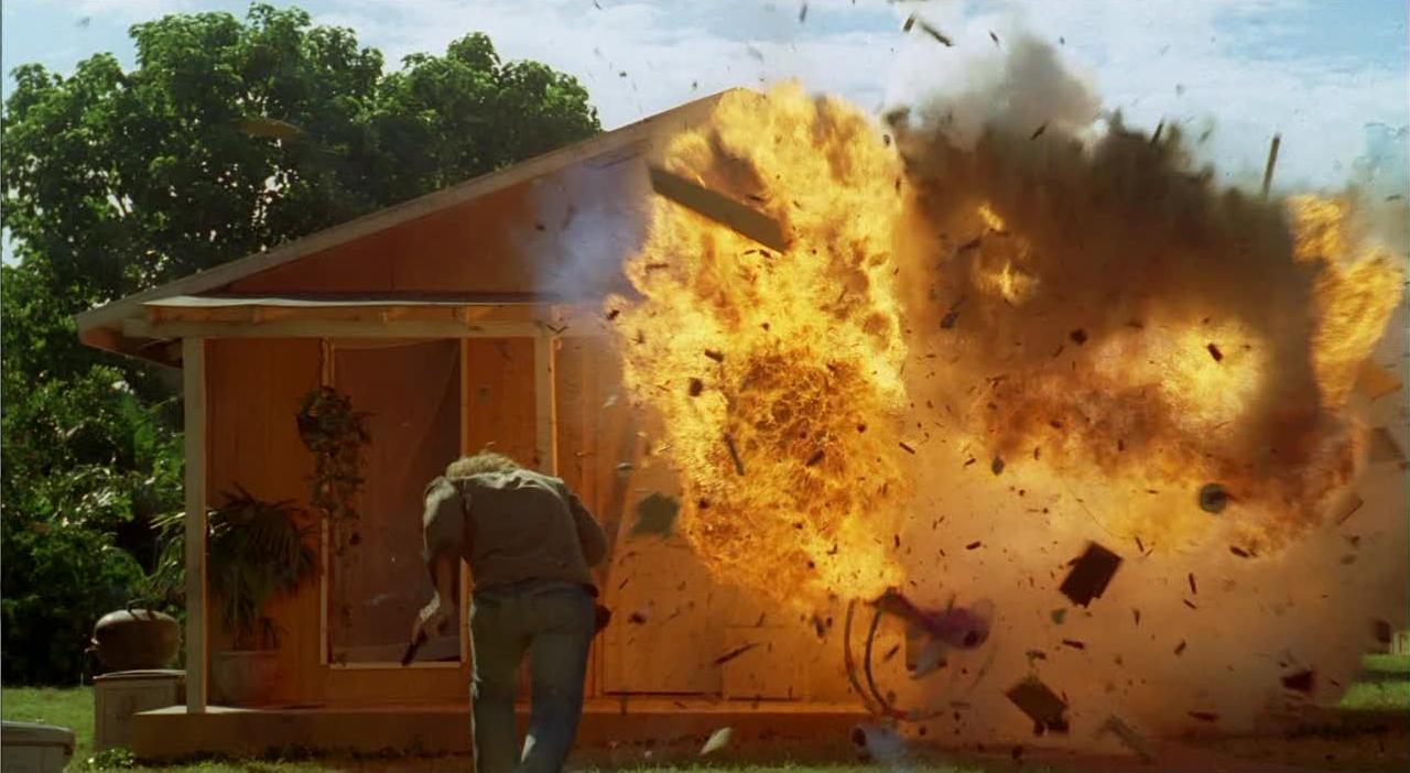 Sawyer runs towards an exploding house in the Barracks