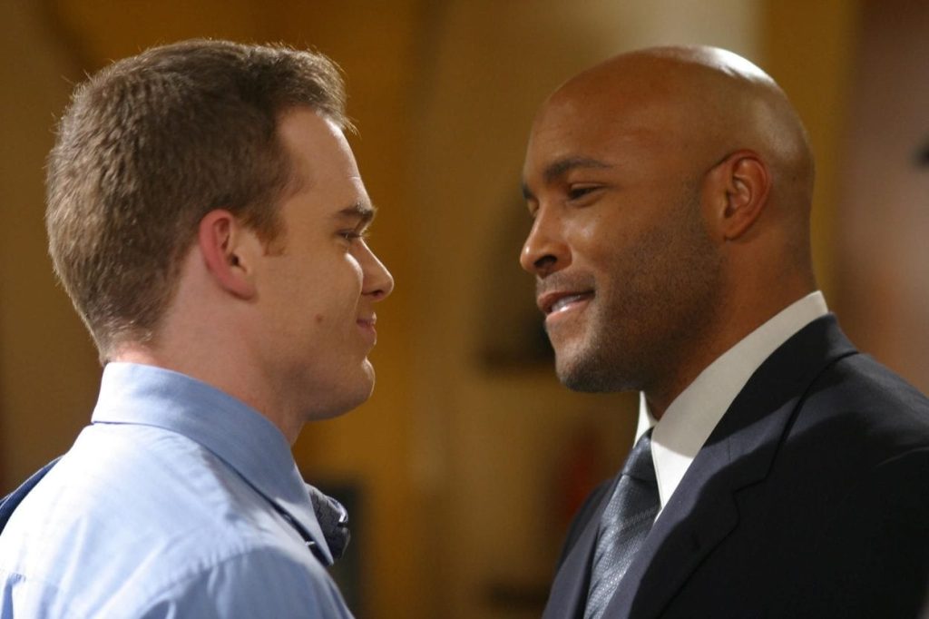 Keith and David stare and smile at each other in Six Feet Under