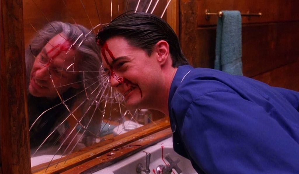 Agent Cooper with BOB in his reflection in the mirror.