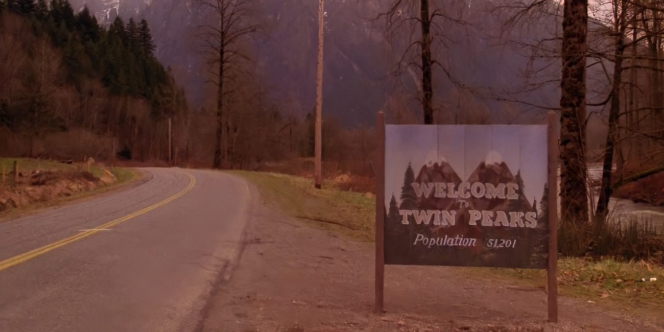 The Twin Peaks sign displays itself on a road