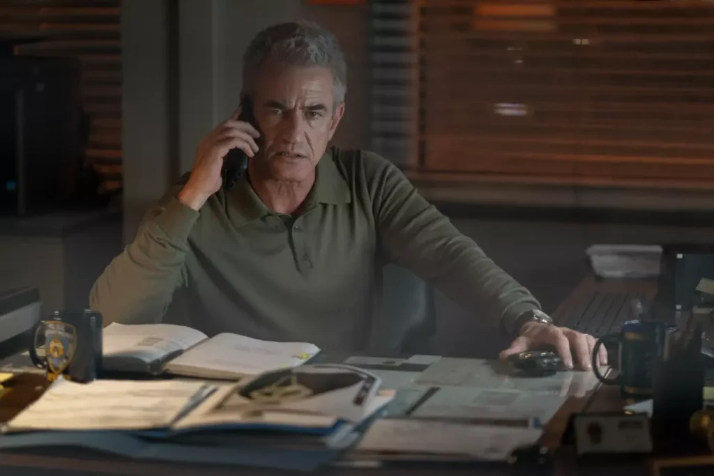 Detective Bailey on the phone at his desk in Scream 6