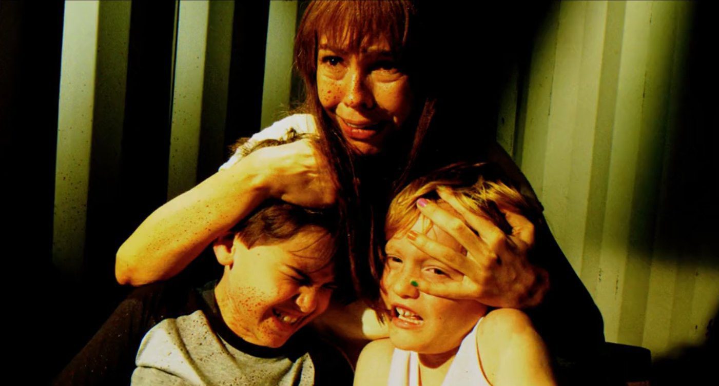 Laura Moser holding her sons before she dies in Dexter: Original Sin Episode 8