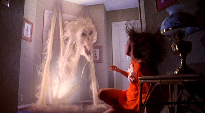 A ghost comes out of the wall in Poltergeist